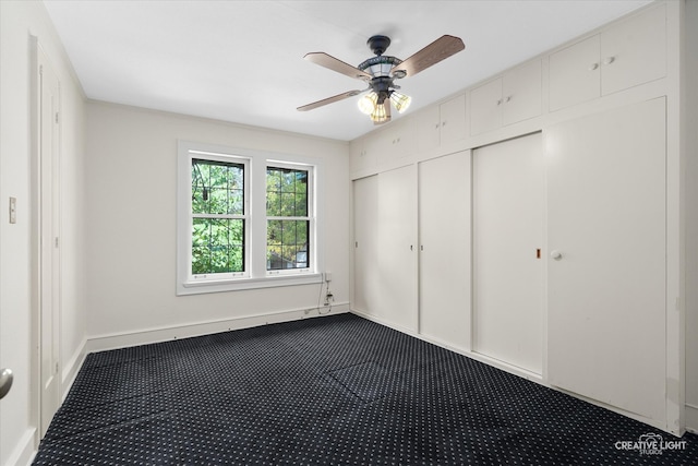 unfurnished bedroom featuring carpet floors, ceiling fan, and a closet