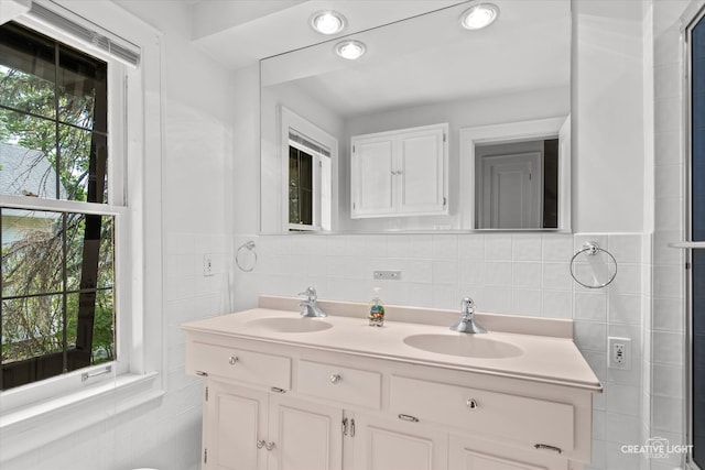 bathroom featuring tile walls, vanity, and a wealth of natural light