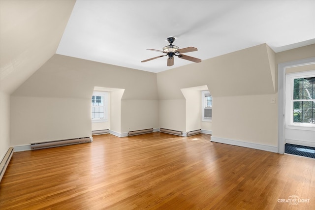 bonus room with a baseboard heating unit, vaulted ceiling, light hardwood / wood-style floors, and ceiling fan