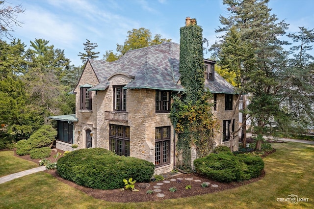 view of side of property with a yard