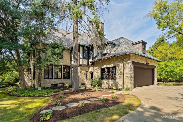 view of front of home featuring a garage and a front lawn