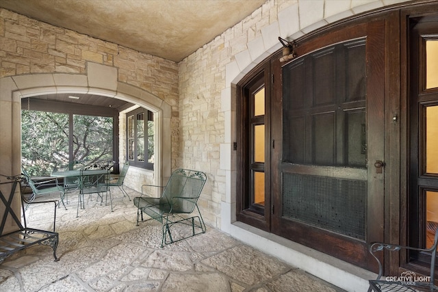 view of exterior entry featuring a patio and french doors