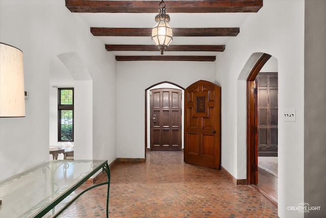 hallway featuring beamed ceiling