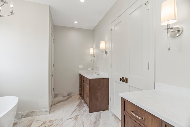 bathroom featuring vanity and a bath