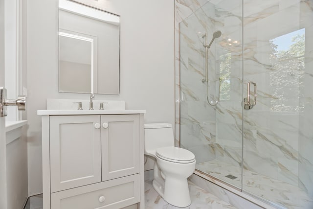 bathroom featuring toilet, a shower with door, and vanity