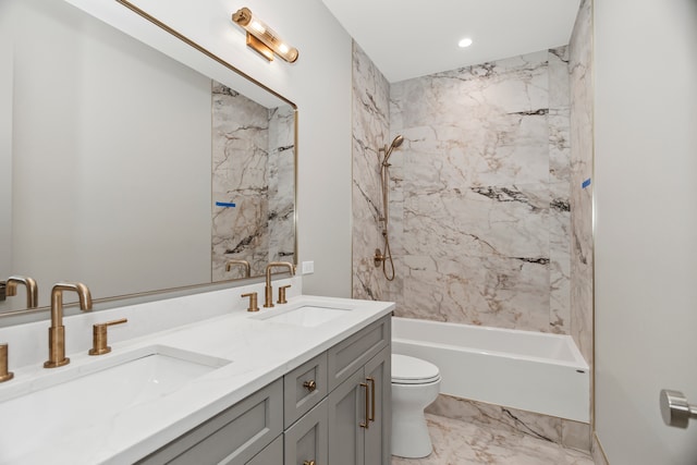 full bathroom featuring tiled shower / bath combo, vanity, and toilet