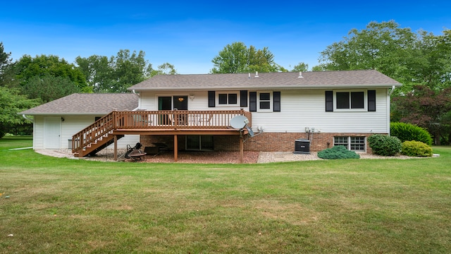 back of property with a wooden deck, a yard, and central air condition unit