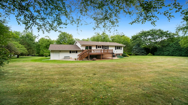 rear view of property featuring a yard and a wooden deck