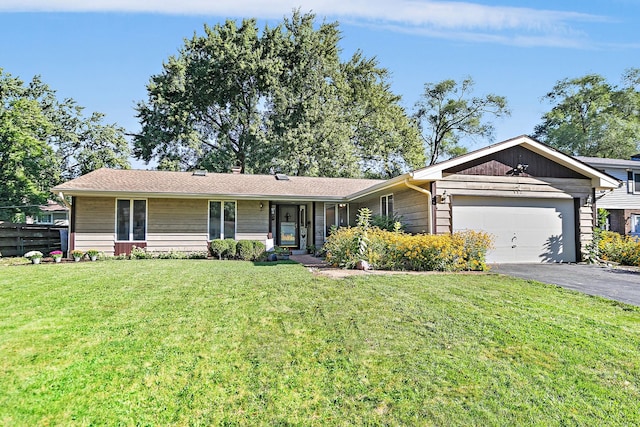 single story home featuring a garage, covered porch, and a front yard