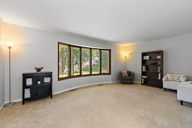 living area with light colored carpet