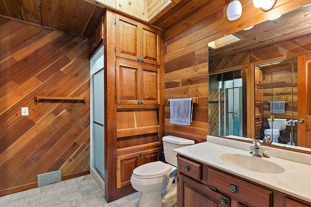 bathroom with a shower with door, vanity, wood ceiling, toilet, and wooden walls