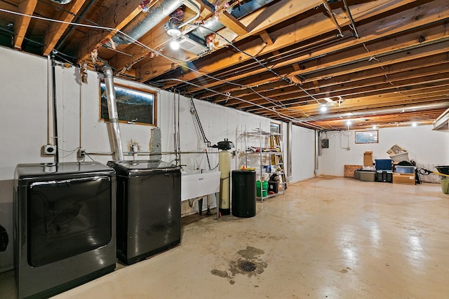 basement featuring separate washer and dryer and sink