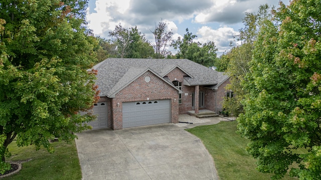 view of front of house featuring a front yard and a garage