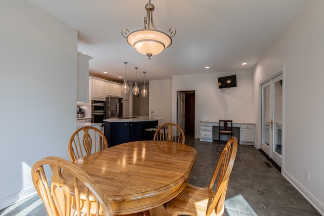 dining room featuring dark tile patterned flooring