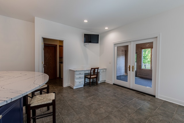 dining room featuring built in desk and french doors