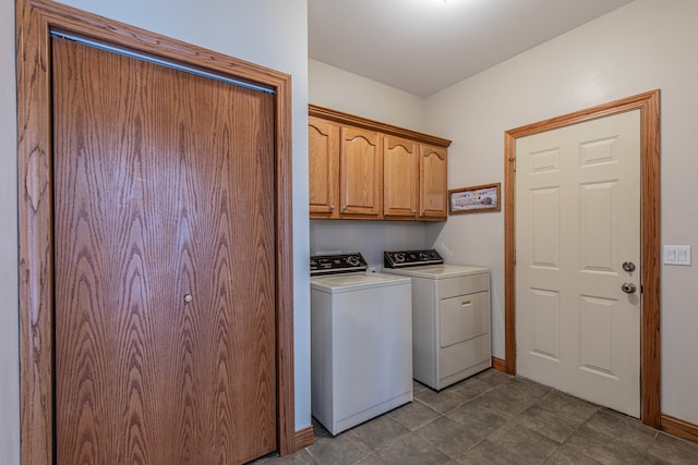 laundry room featuring cabinets and washer and clothes dryer