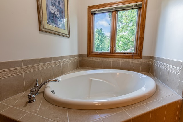 bathroom with a wealth of natural light and tiled bath