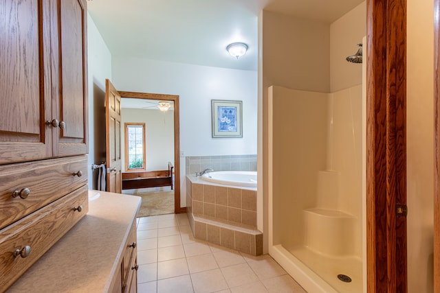 bathroom with plus walk in shower, tile patterned flooring, and vanity