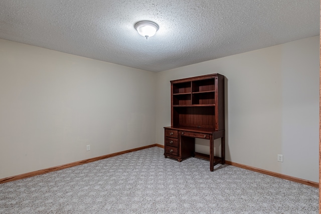 unfurnished office with light colored carpet and a textured ceiling