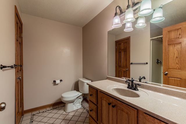 bathroom with vanity, toilet, tile patterned floors, and a textured ceiling