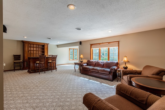 carpeted living room featuring a textured ceiling