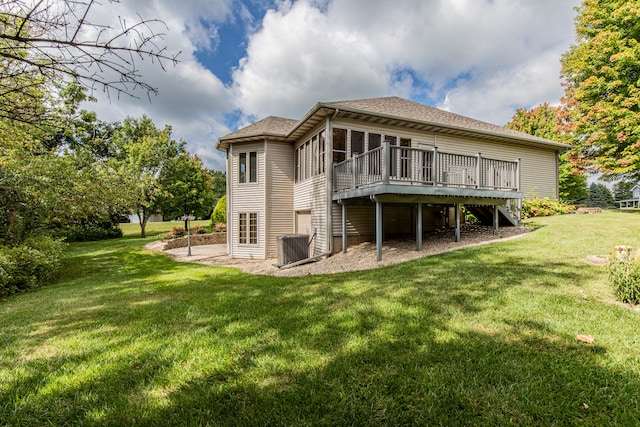 rear view of house featuring a yard and a deck