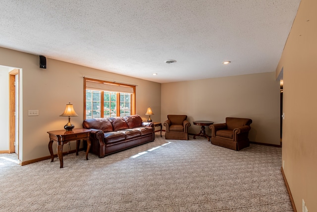 living room with light carpet and a textured ceiling