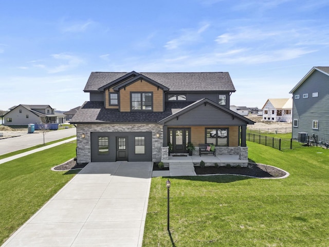 craftsman house with concrete driveway, fence, a porch, and stone siding