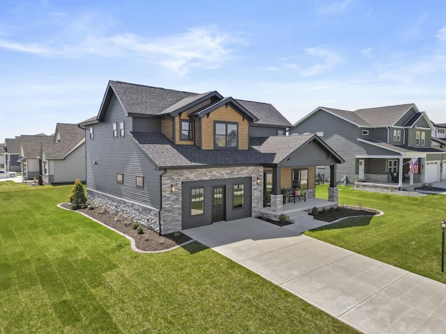 view of front of home featuring a residential view, stone siding, a shingled roof, and a front yard