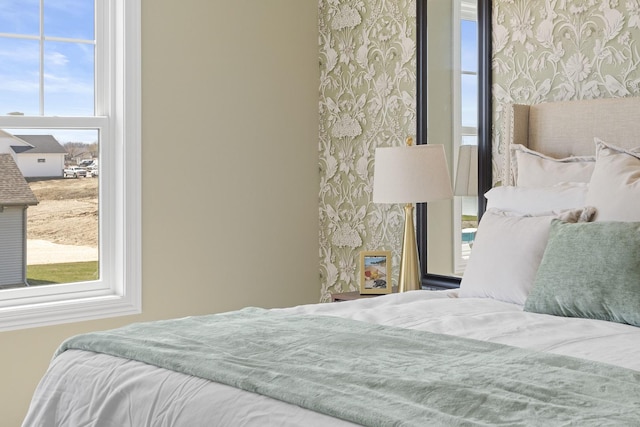 bedroom with wallpapered walls