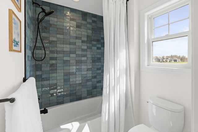 bathroom featuring toilet and shower / bath combo with shower curtain