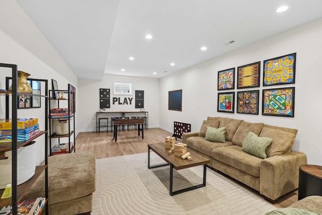 living room with light wood finished floors, baseboards, and recessed lighting