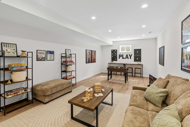 living room featuring light wood finished floors, baseboards, and recessed lighting