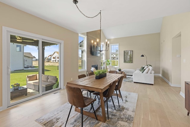dining room featuring plenty of natural light, baseboards, and light wood-style floors