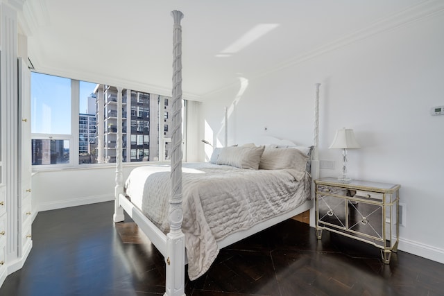 bedroom with dark hardwood / wood-style floors and crown molding