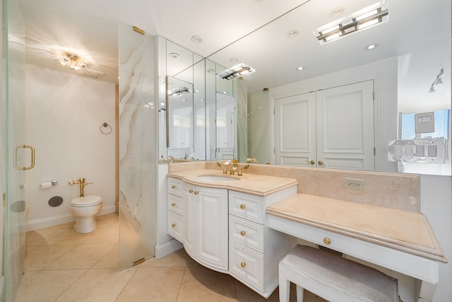 bathroom with tile patterned flooring, vanity, and toilet