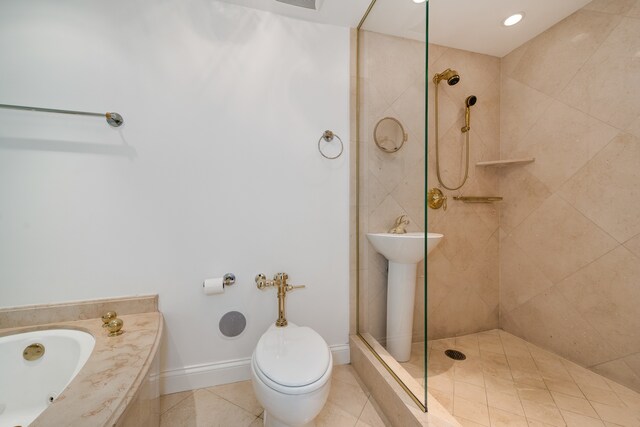 bathroom featuring tile patterned flooring, toilet, and independent shower and bath