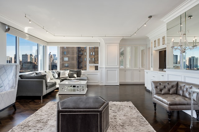 living room with crown molding, dark parquet floors, and a notable chandelier