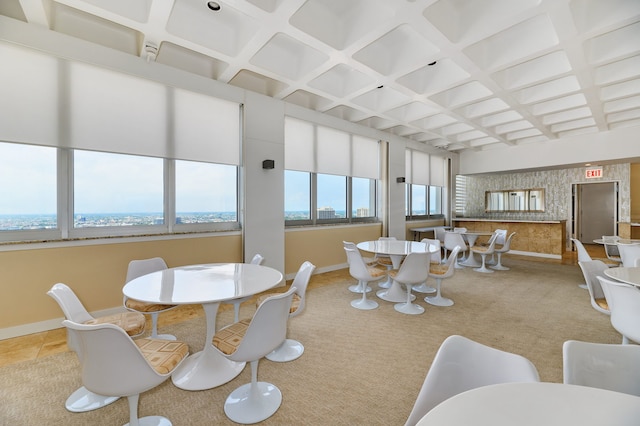 tiled dining room featuring beam ceiling and coffered ceiling