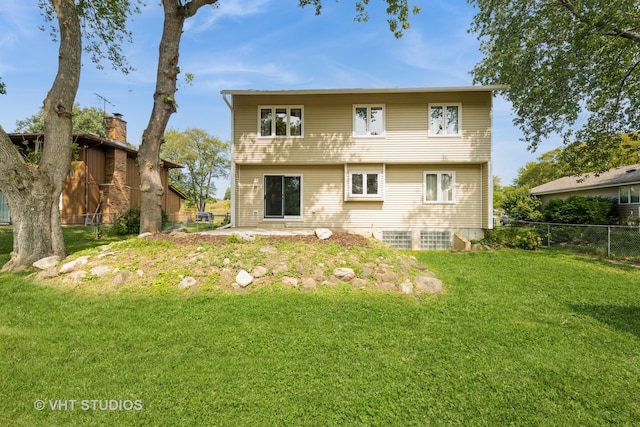 rear view of house featuring a yard and a patio area