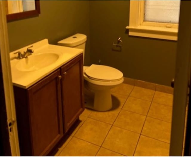 bathroom featuring tile patterned flooring, vanity, and toilet