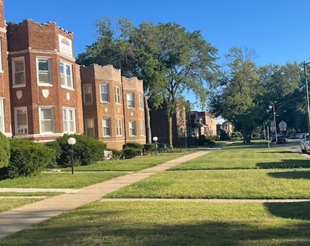 view of home's community featuring a lawn