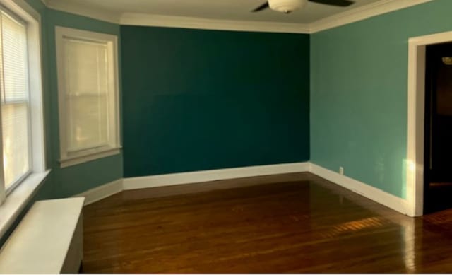 spare room with ornamental molding, ceiling fan, and dark hardwood / wood-style flooring