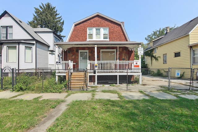 bungalow featuring a front lawn and a porch