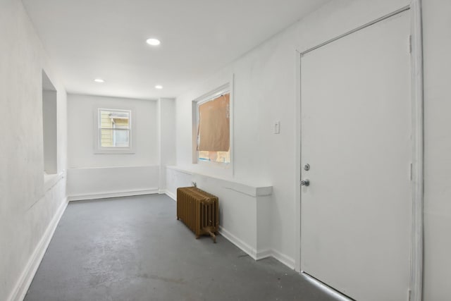 corridor with radiator and concrete flooring