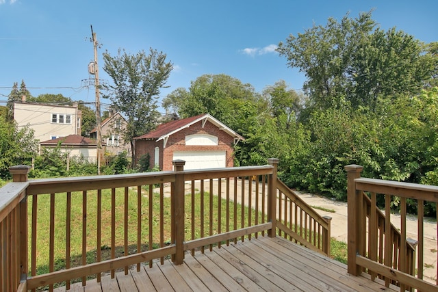 wooden deck featuring a garage and a yard