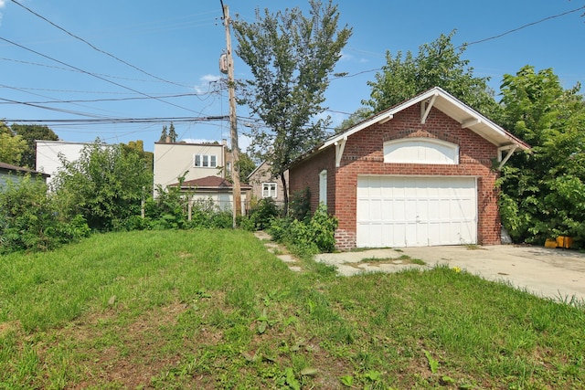 exterior space featuring a garage and a yard