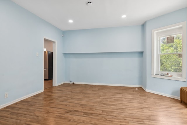 unfurnished room with light hardwood / wood-style flooring