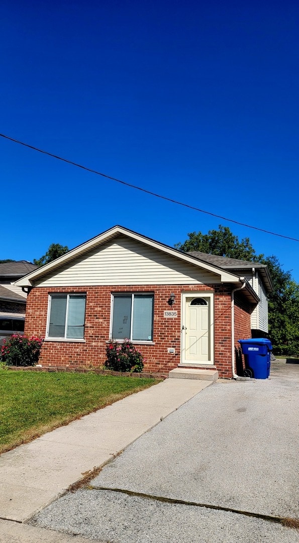 view of side of home with a yard