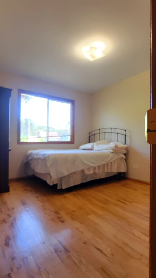 unfurnished bedroom with hardwood / wood-style floors